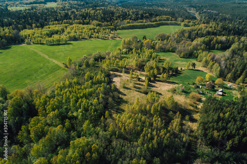 Aerial view on rural forest area with small road 