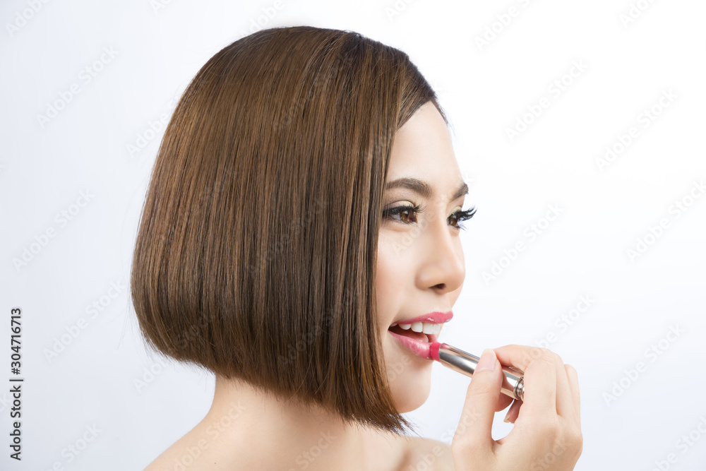 Beautiful Asian woman. She is makeup and applying lip paint. Beautiful Asian woman. She is makeup and applying lip paint.