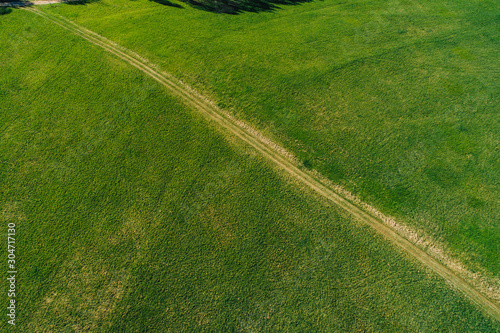 Aerial view on rural forest area with small road 