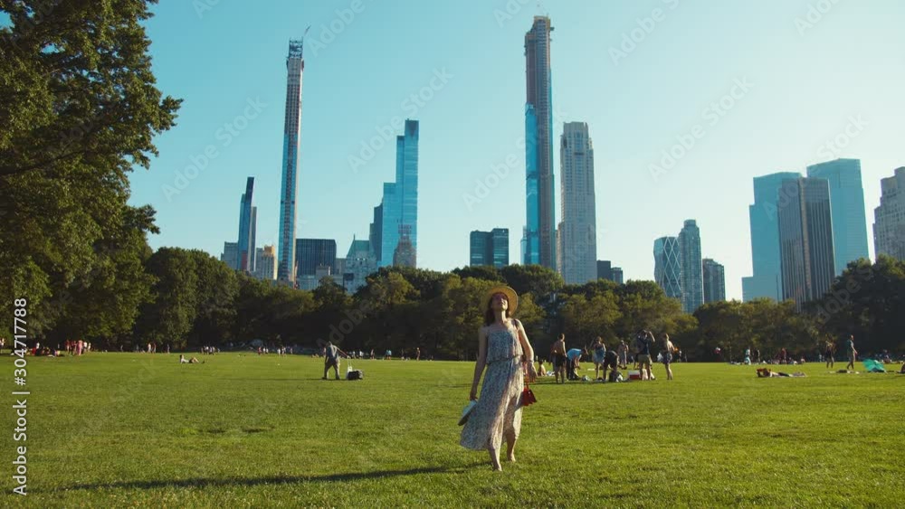 Young girl walking on the lawn in Central Park