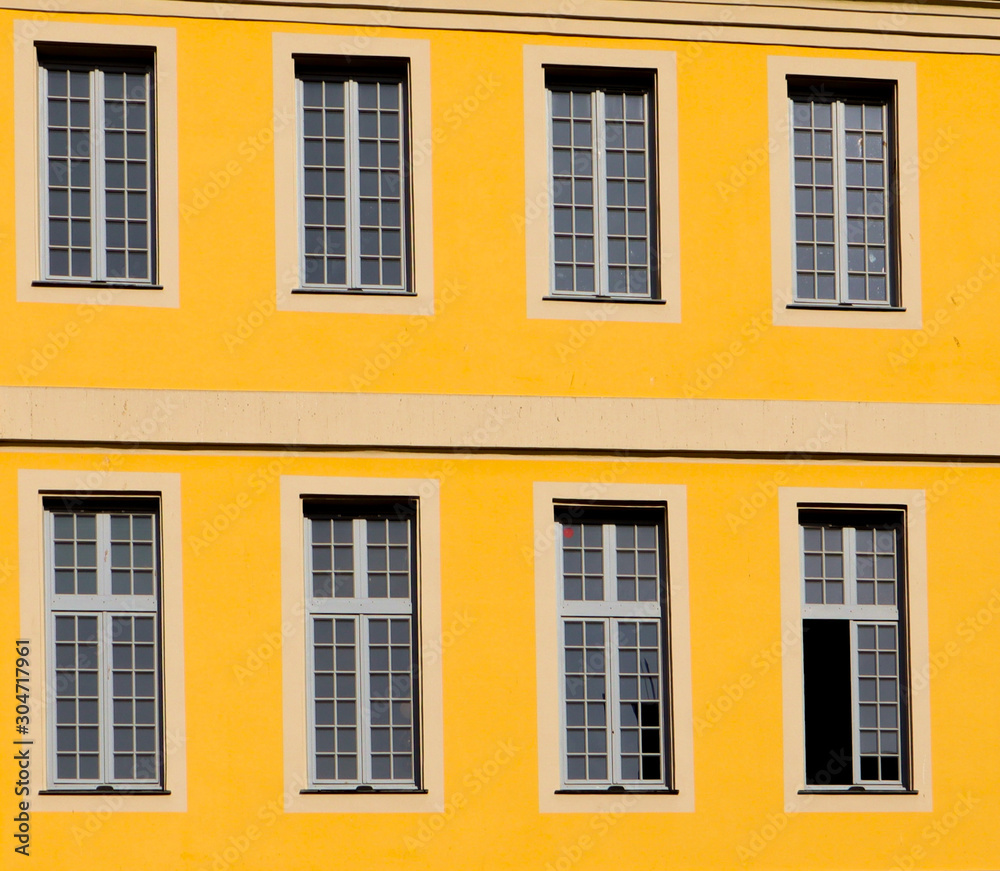 A yellow walled building with windows