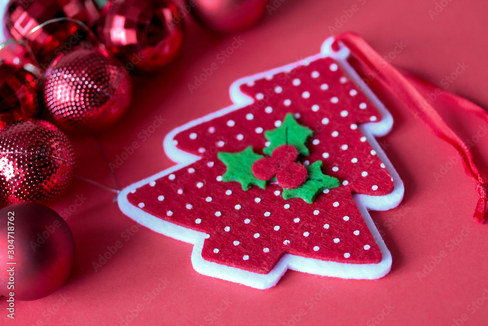 Felt dotted fir tree with holly berry on red background. Christmas and New Year festive handmade decoration. Greeting card, poster template. Red round ornaments Felt dotted fir tree with holly berry on red background. Christmas and New Year festive handmade decoration. Greeting card, poster template. Red round ornaments