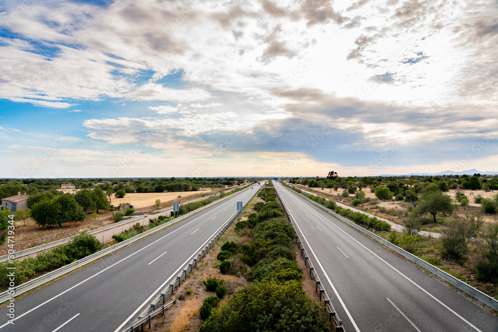 Spectacular views of a motorway in Mallorca called Autopista de Levante in Spanish, with an impressive sky and a well-defined horizon