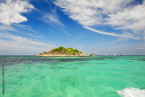 Talu Island. Koh Talu in Tarutao National Park of Satun province Thailand.Mountain and beach with blue sky cloudy. Cave entrance. Cave hole inside. Sea and mountain hope. photo