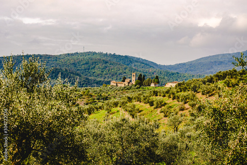 View of Ss. Mary and Leonard parsih church in Artimino with typical tuscan landscape photo