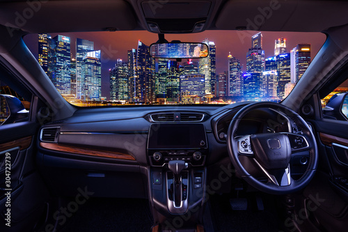 Looking through a car windshield with cityscape at night. Travel in car. © tawatchai1990