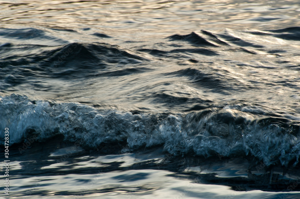 Small waves break before reaching the beach