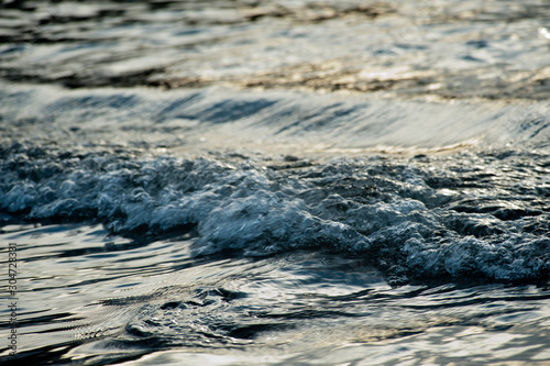 Small waves break before reaching the beach