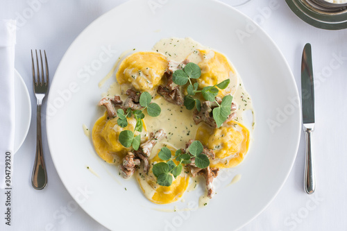 ravioli in a creamy sauce with chanterelles. Top view.