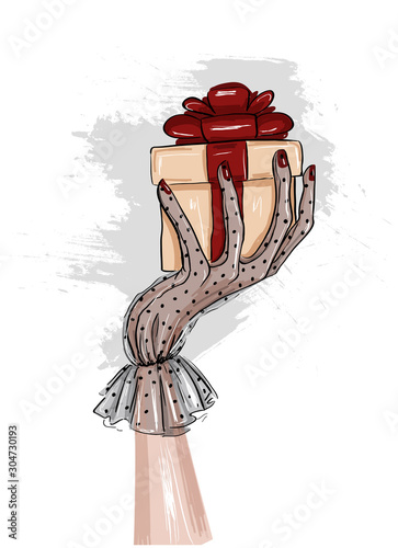 woman hand in glove holding a present