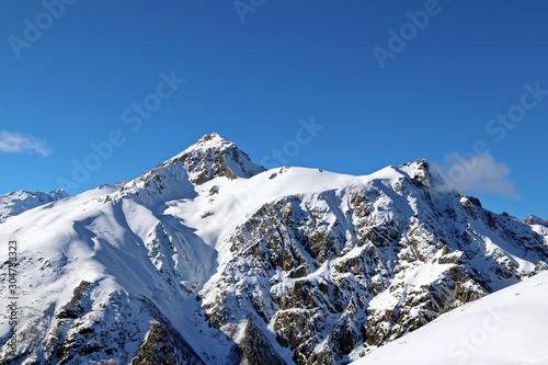 Snowy Mountains peaks in the clouds blue sky Caucasus © Mokrousov Boris