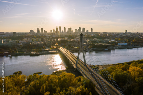 Aerial view of a beautiful cityscape with bridges, a river, and a sports stadium against the backdrop of sunrise. Warsaw, Poland. 19. October. 2019. 