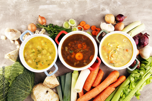Set of soups from worldwide cuisines, healthy food. Broth with noodles, beef soup and broth with marrow dumplings. All soups with healthy vegetables on table photo