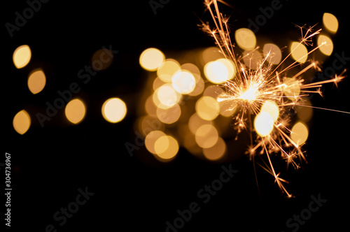 Sparkler and light bokeh background.Abstract and brightly colorful firework in the celebration and anniversary festival.Merry Christmas and New year party light over night sky.