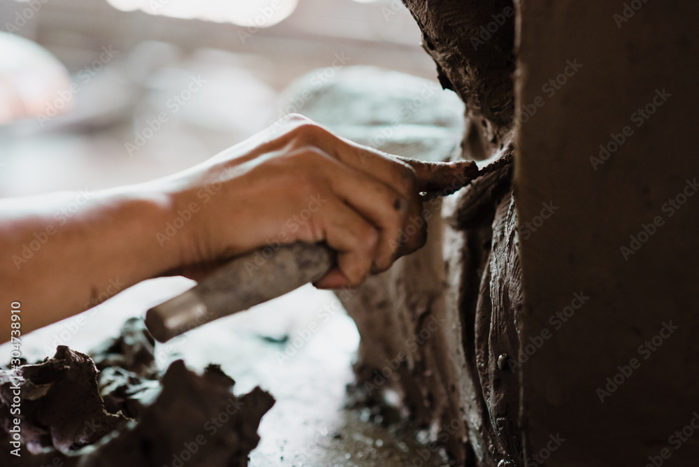 Selective focus sculptor hand molding clay.Professional artist worker creating a statue sculpture with wet clay. Selective focus sculptor hand molding clay.Professional artist worker creating a statue sculpture with wet clay.