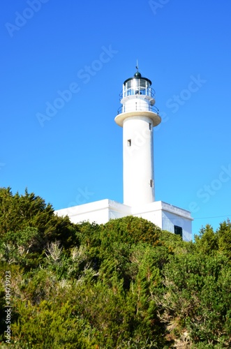 Lefkada island  Greece. 10 21 2019.  white lighthouse and green trees on the edge of Lefkada island