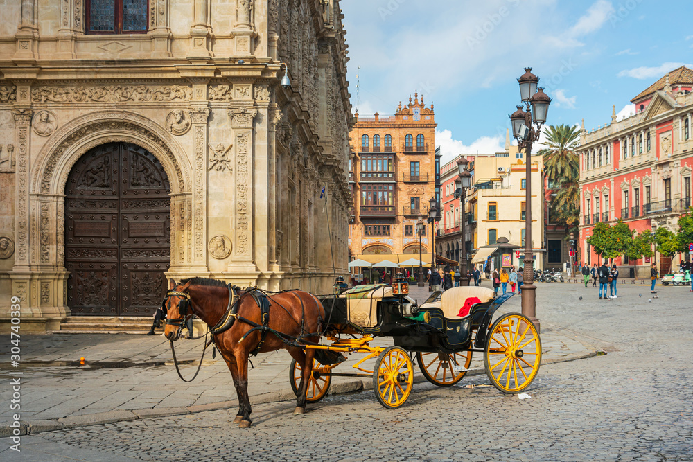 Fototapeta premium Sewilla, Hiszpania - 13 stycznia 2018 r .: konie i dorożką przewozi turystów w Sewilli, Hiszpania