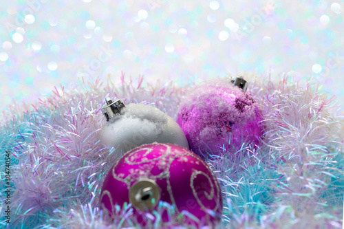 Christmas balls with blue tinsel on the snow
