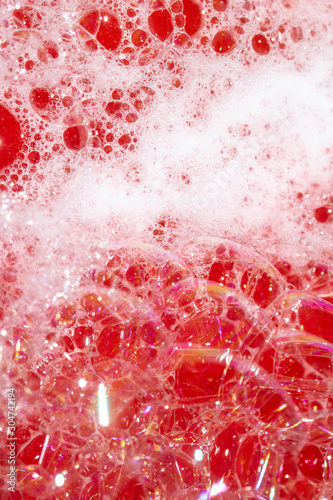 Close Up of Bath Water Bubbles Foam For Background In Red Pink