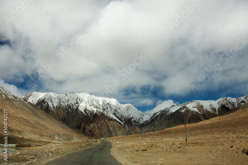 View landscape with Himalayas mountains and between journey Pangong Tso high grassland lake go to Leh Ladakh on Pangong lake road and Khardung La Road while winter season in Jammu and Kashmir, India