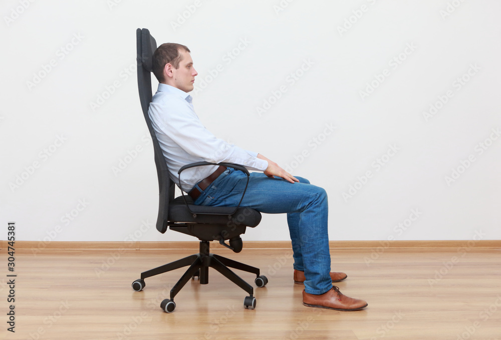 Caucasian man sitting on office chair in relaxed position
