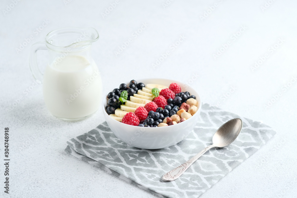 Oatmeal with berries and fruits on a light background. Healthy breakfast. Oatmeal with berries and fruits on a light background. Healthy breakfast.
