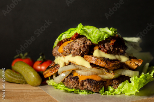 Keto burger, lettuce wrapped burger, stacked with 2 patties, mushrooms, onion, sundried tomato, cheese and mayo. Served with pickle and tomato.