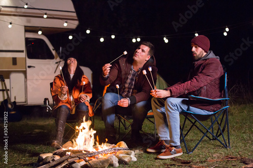 Girl laughing and holding hot marshmallow