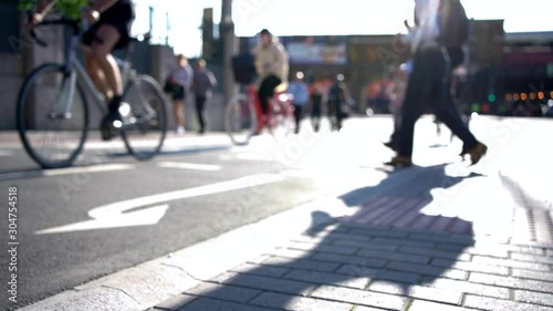 Cyclists And Pedestrians Crossing Road In Slow Motion On Way To Work In City