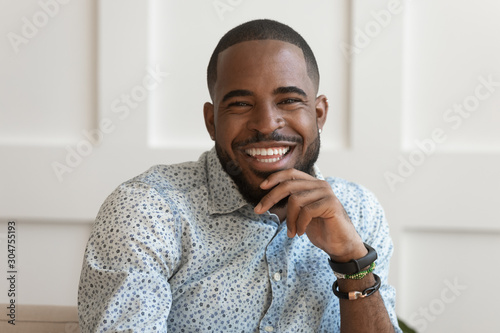 Portrait of smiling biracial man look at camera laughing