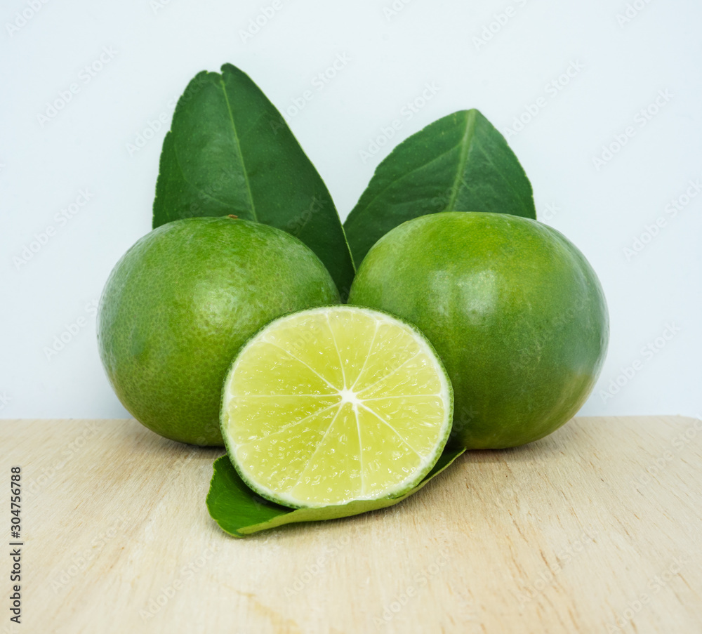 set of green fresh limes slice isolated on chopping block set of green fresh limes slice isolated on chopping block