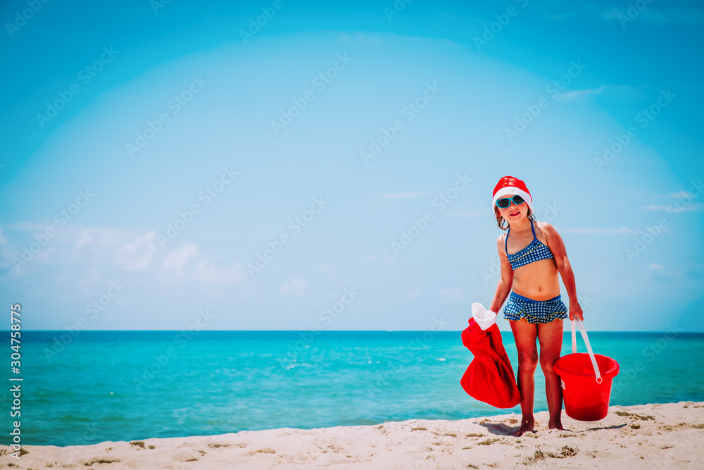cute little girl celebrating christmas on tropical beach