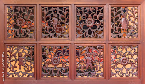 Decorative carvings wood panel with flowers patterns and asian children characters in the choanji temple.