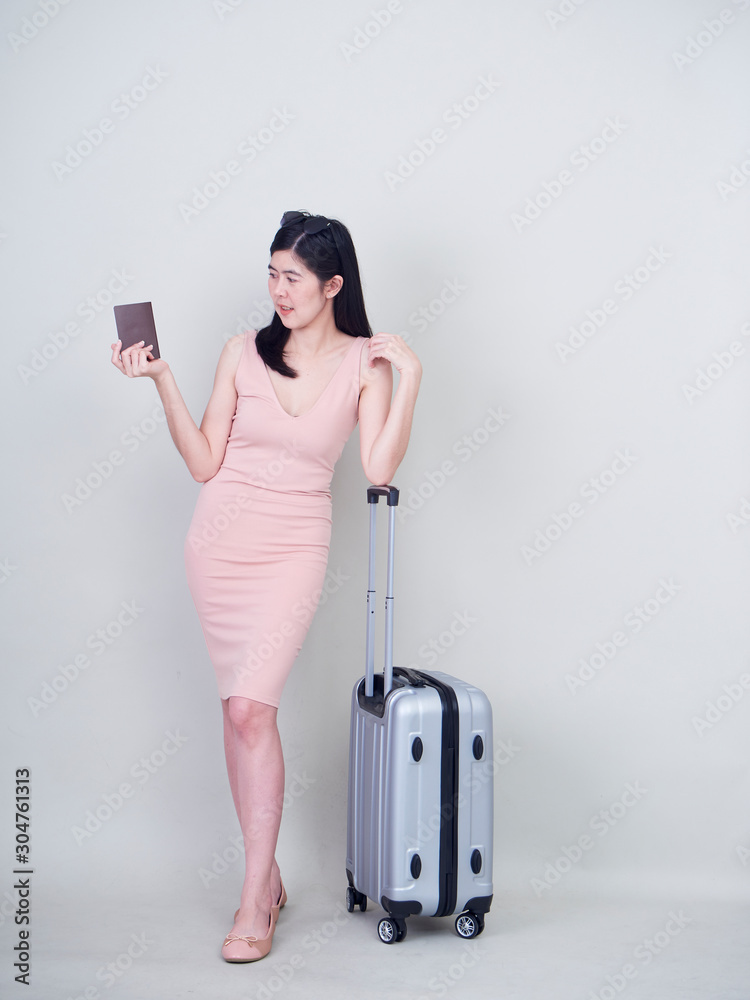 Young woman with suitcase on white background Stock-Foto | Adobe Stock