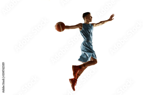 Full length portrait of young basketball player with a ball isolated on white studio background. Teenager training and practicing in action, motion. Concept of sport, movement, healthy lifestyle, ad.