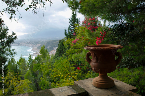 clay vase with view in the background of Giardini Naxos seen from Taormina, Sicily, Italy