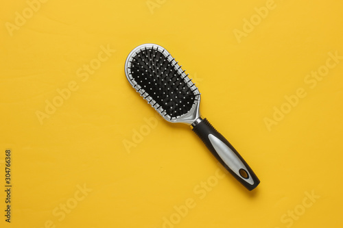 Принти на полотні Stylish hairbrush on yellow background