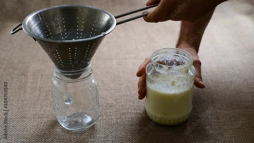 Homemade preparation of milk Kefir, separating the granules with a