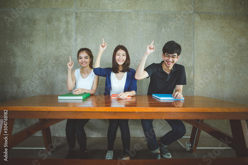 Group of young casual students studying together in of university education concept.