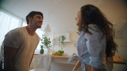 Closeup happy couple dancing at kitchen. Beautiful lovers having fun at home.