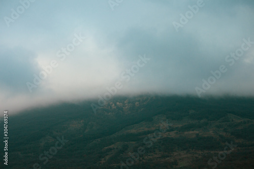 Heavy dense fog in the mountains near the road.