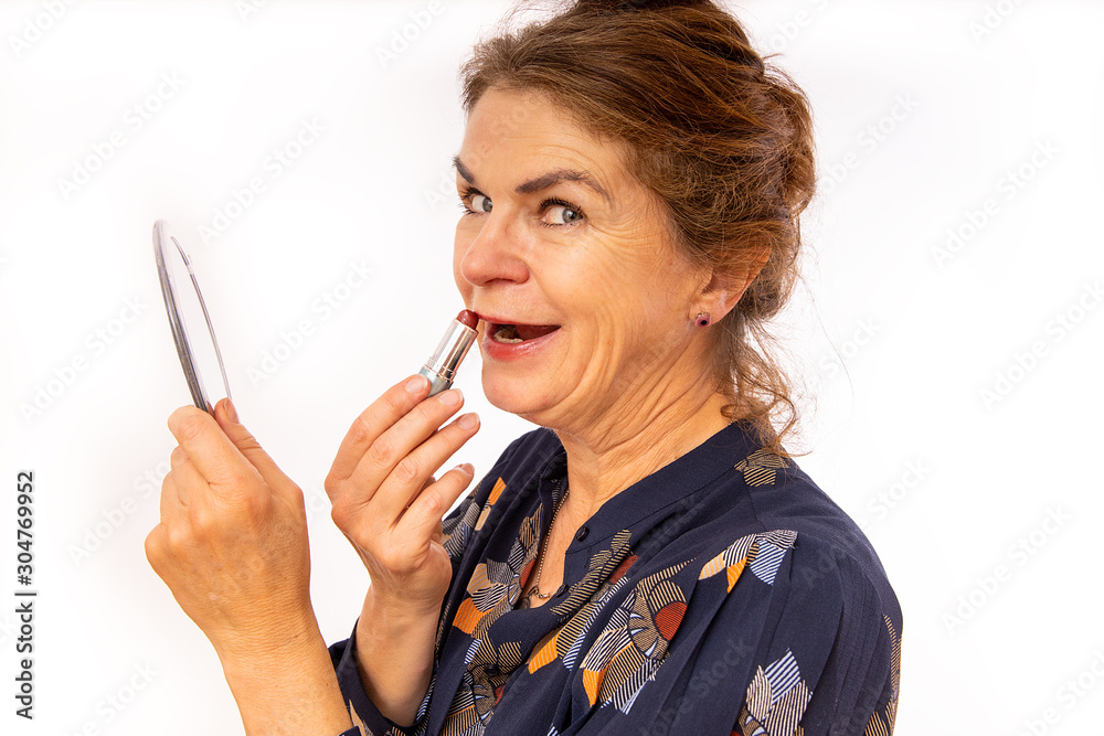 Elegant middle-aged woman cares for her lips Elegant middle-aged woman cares for her lips