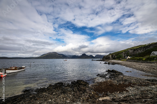 Beautiful scenic landscape of amazing Scotland nature with fishing boat.