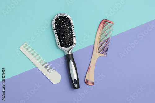 Combs on blue-purple pastel background. Beauty minimalistic concept. Hair care. Top view