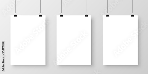 Realistic hanging blank paper sheet with shadow in A4 format and black paper clip, binder on gray background. Design poster, template or mockup. Vector illustration.