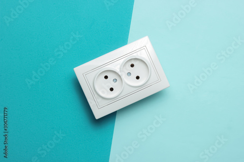 Billede på lærred Double power socket on a blue pastel background