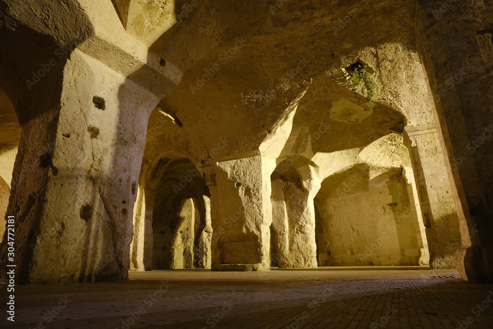 Sassi of Matera in Italy. Underground entry to the tanks called Palombaro illuminated by the lucenotturna of the sodium lamps.