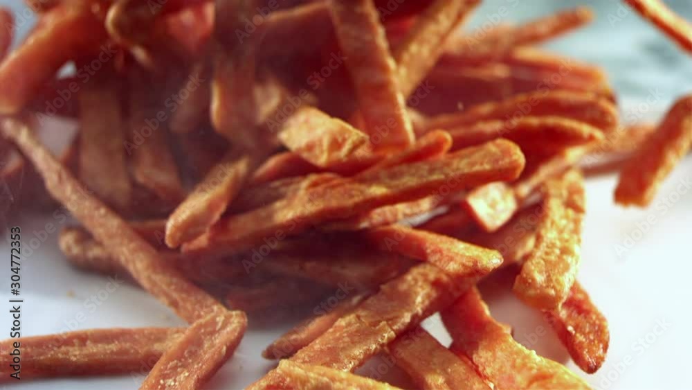 French fries land on counter to in slow motion French fries land on counter to in slow motion