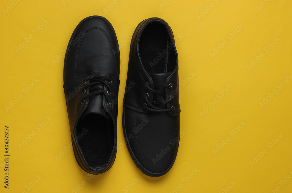 Men's leather black shoes on paper background. Top view
