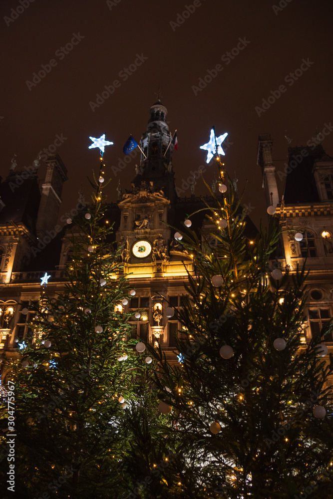 Parisian City Hall (Hotel de Ville) decorated for Christmas at night.  Paris, France.  Europe winter travel concept.